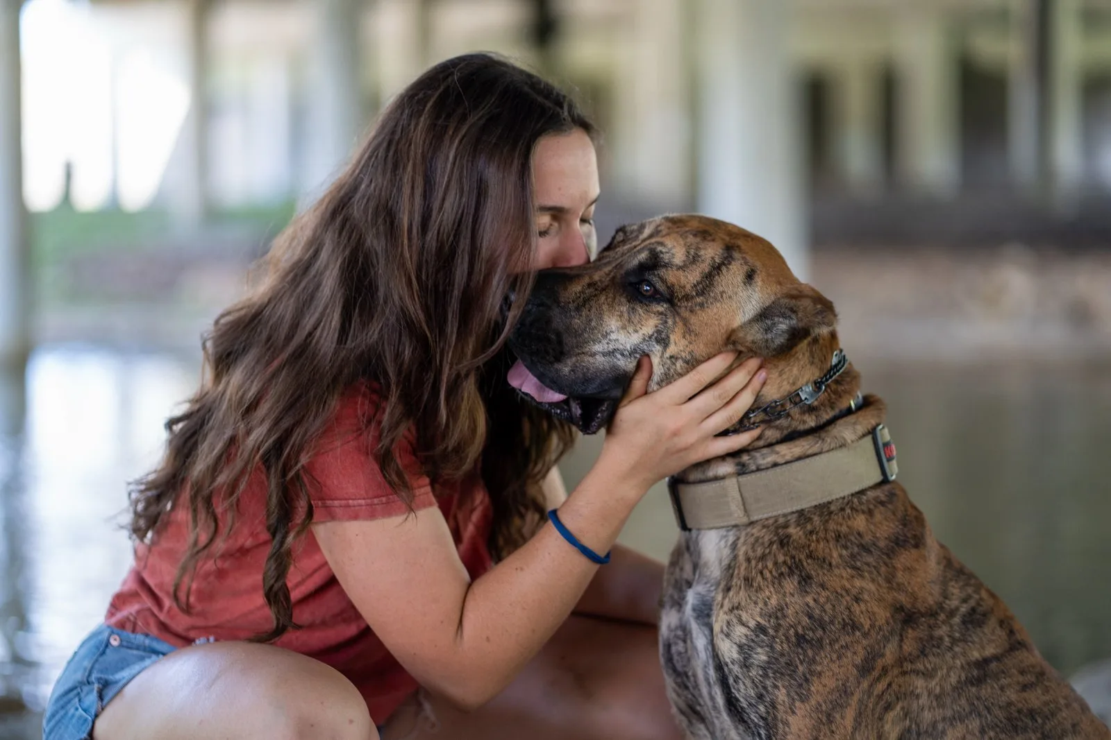 A Caliber K9 client sharing a trusting moment with her dog
