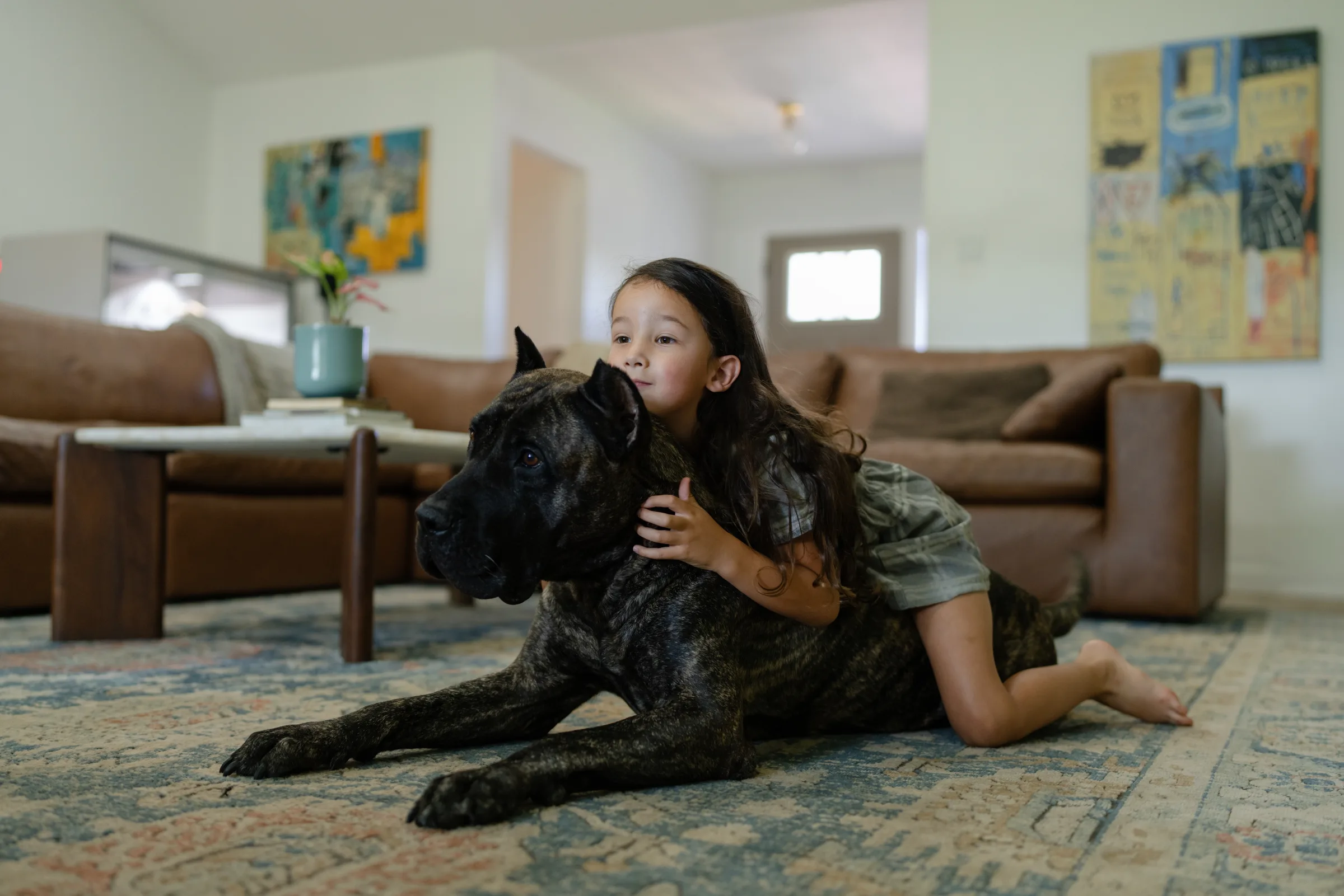 A child confidently relaxing with a trained family dog