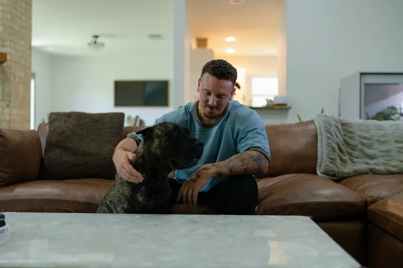 Isaac with a dog in the home where Caliber K9 trains